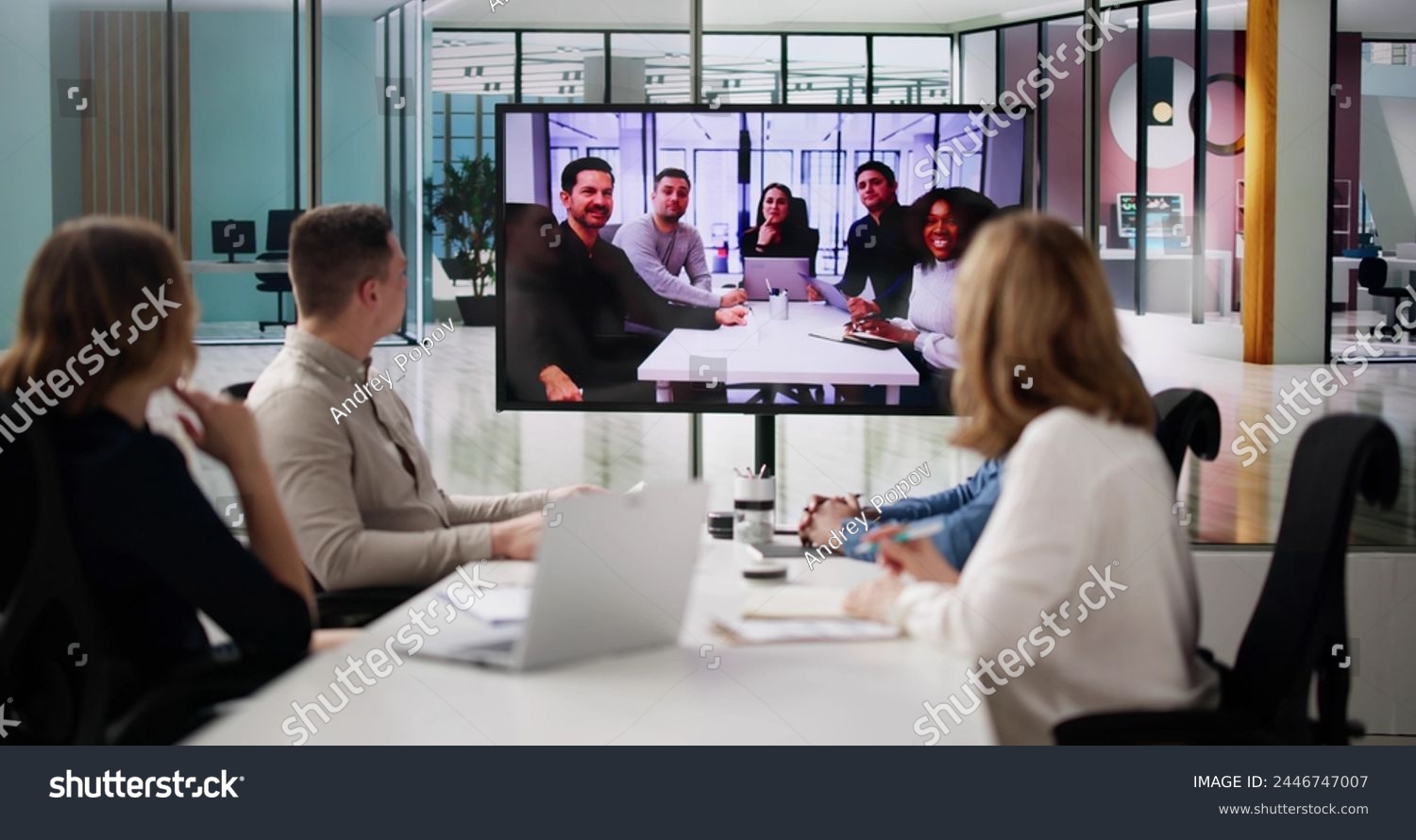 stock-photo-group-of-businesspeople-having-video-conference-with-another-business-team-2446747007